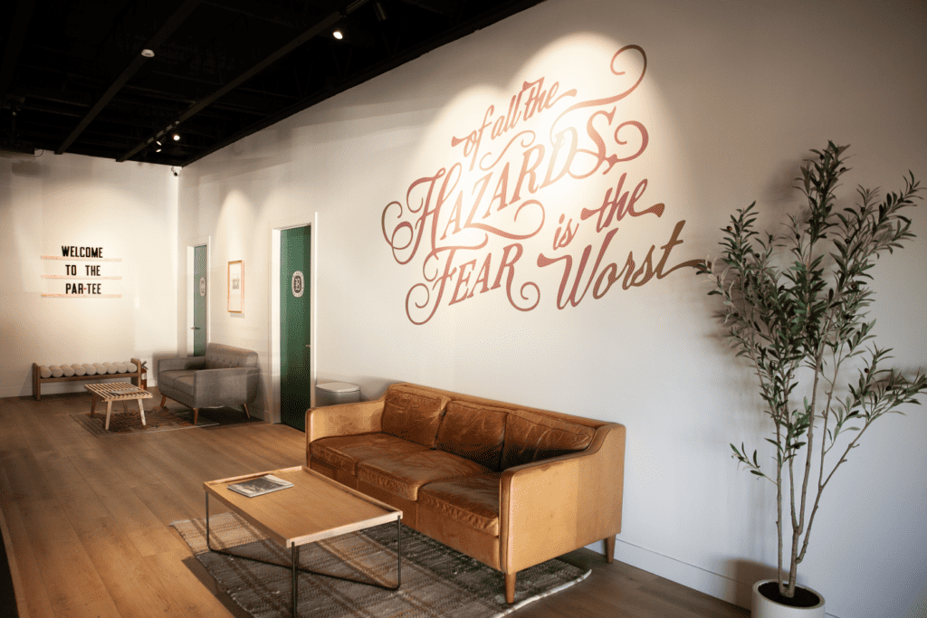 Stylish lounge with motivational wall quote and seating